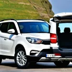 Home 11 쌍용 토레스의 적재 공간 분석 - **Prompt 1: Initial Impression of Spacious Trunk**
A dynamic, eye-level shot of a modern SsangYo...